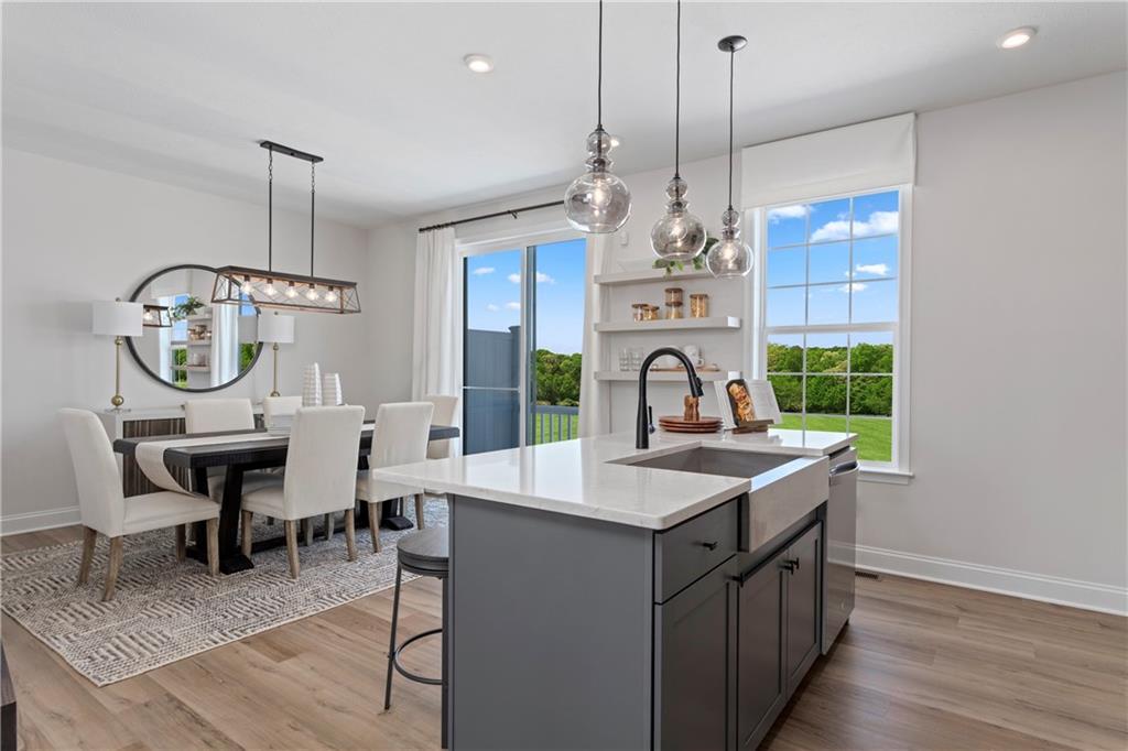 111 Affinity Drive Harmony, PA 16037 - Photo 5 of 16 a kitchen with sink refrigerator dining table and chairs