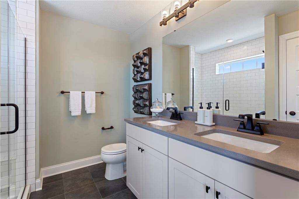 111 Affinity Drive Harmony, PA 16037 - Photo 7 of 16 a bathroom with a granite countertop sink a toilet and a mirror
