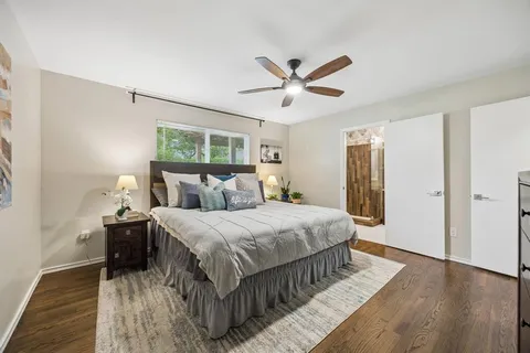 a bedroom with a bed and wooden floor