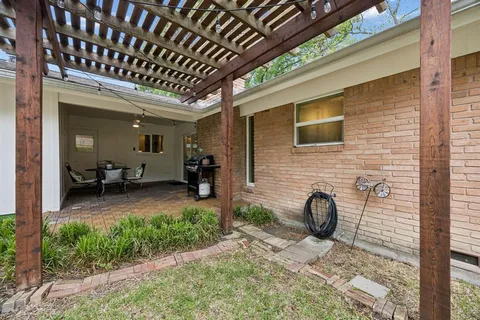 a view of a porch with furniture and a yard
