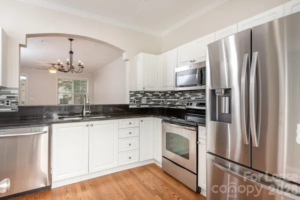 a kitchen with stainless steel appliances a stove sink and refrigerator