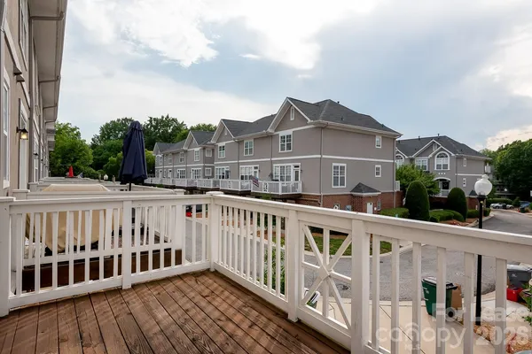 a view of a street with wooden fence