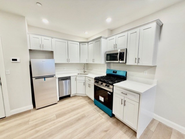 220 Winthrop Street, Unit 301 Winthrop, MA 02152 - Photo 4 of 8 a kitchen with a stove a sink and a refrigerator