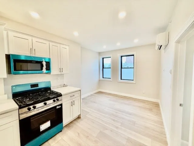 a kitchen with stainless steel appliances granite countertop a stove and a microwave