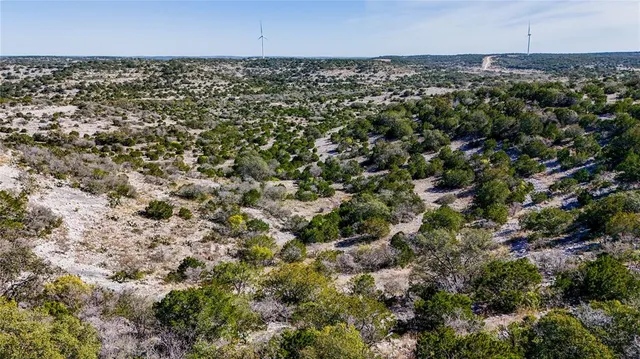 an aerial view of a houses with a yard