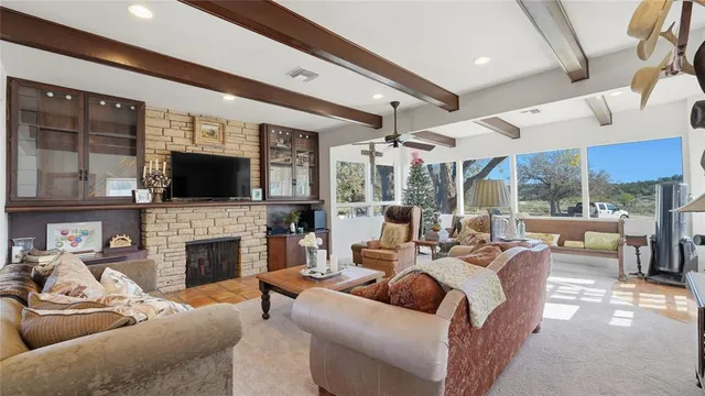a view of a kitchen with kitchen island a large window a sink and stainless steel appliances