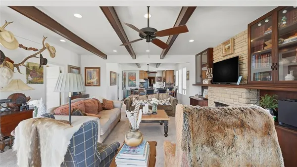 a dining room with furniture a window and wooden floor