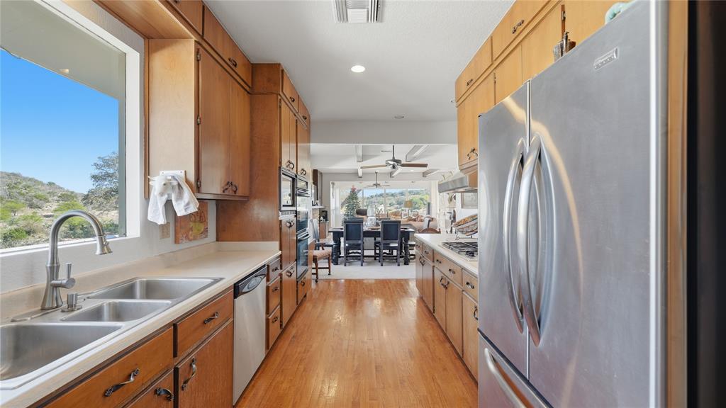 Undisclosed Address Del Rio, TX 78840 - Photo 21 of 40 a view of a kitchen with kitchen island a large window a sink and stainless steel appliances