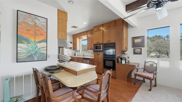 a bathroom with a sink a toilet a mirror and shower