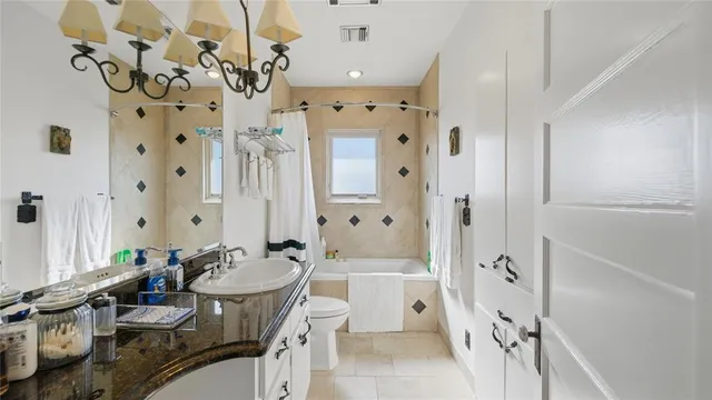 a bathroom with a sink vanity granite tub and shower