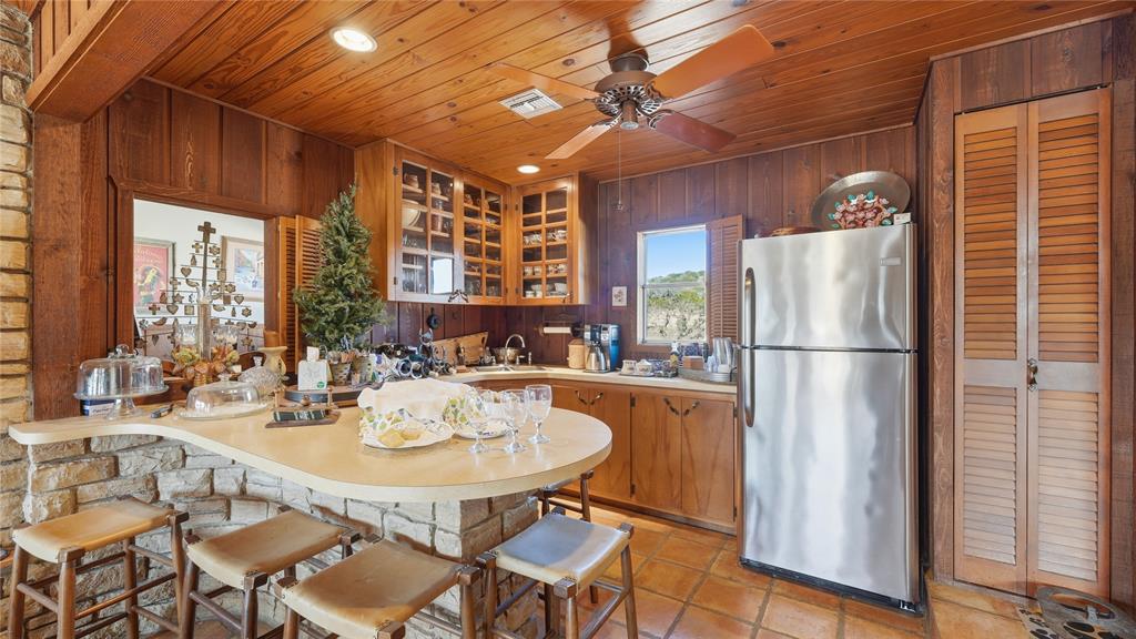 Undisclosed Address Del Rio, TX 78840 - Photo 29 of 40 a kitchen with a refrigerator a table and chairs in it