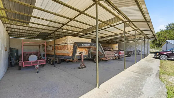 a living room with patio furniture and a floor to ceiling window