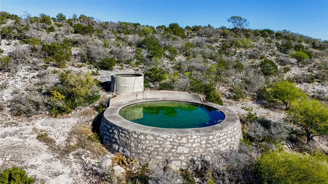 a view of a swimming pool with a yard