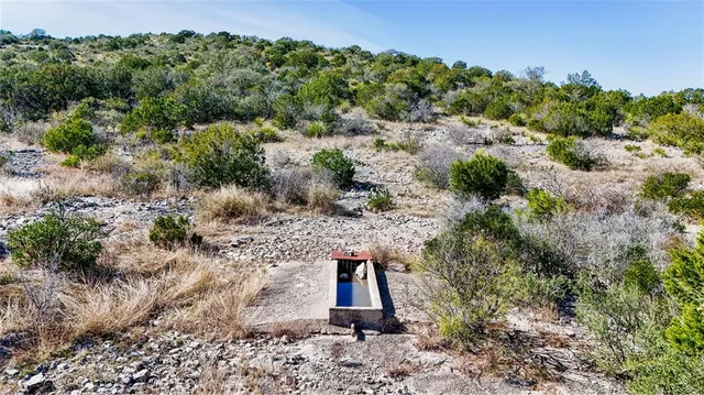 an aerial view of a houses with a yard