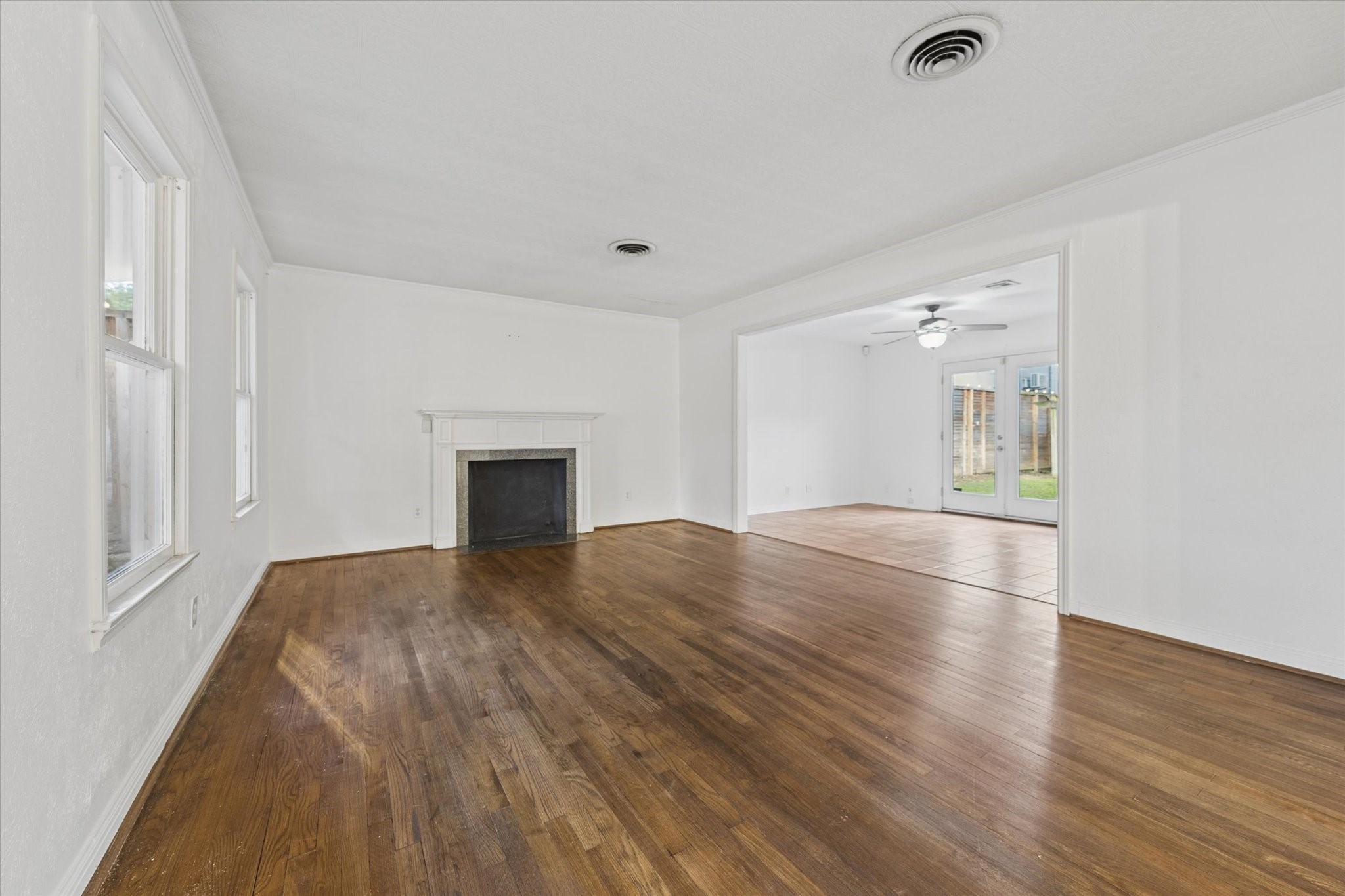 1931 Bissonnet Street Houston, TX 77005 - Photo 5 of 22 a view of empty room with wooden floor and fireplace
