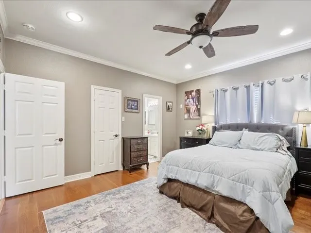 a bedroom with a large bed and a chandelier