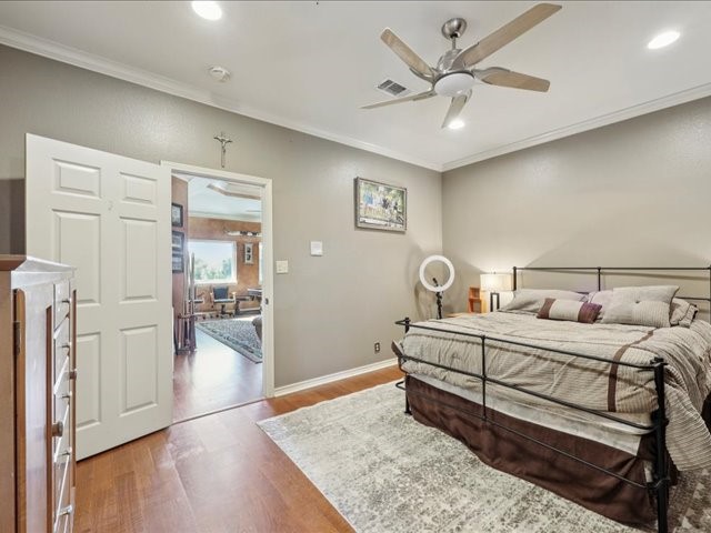 2700 Spurlock Road Nederland, TX 77627 - Photo 15 of 44 a bed room with a bed and a ceiling fan