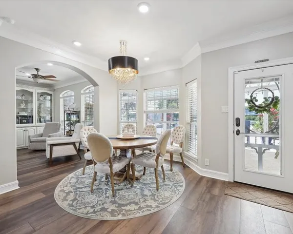 a view of a dining room with furniture wooden floor and chandelier