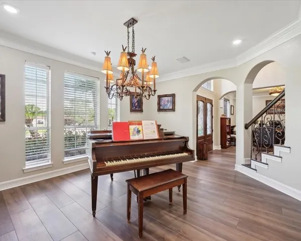 a living room with furniture and a chandelier