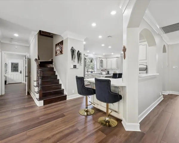 a view of kitchen with granite countertop cabinets and wooden floor