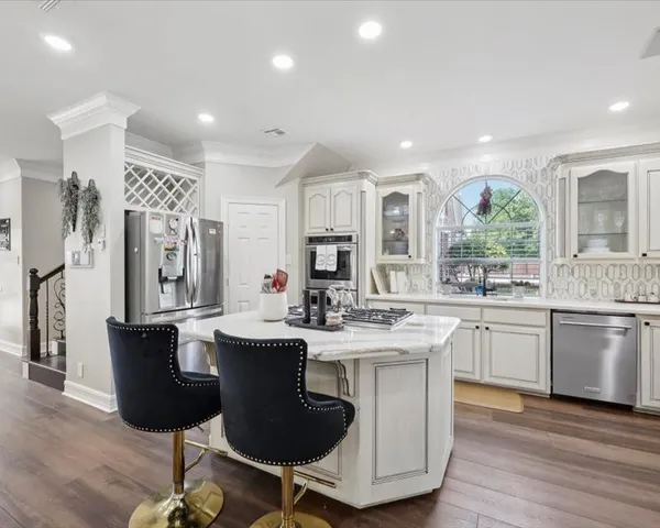 a kitchen with kitchen island granite countertop a sink and cabinets