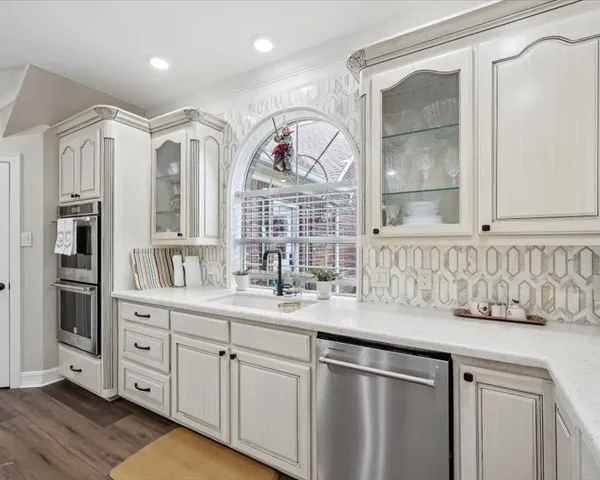 a kitchen with stainless steel appliances granite countertop a sink and wooden cabinets