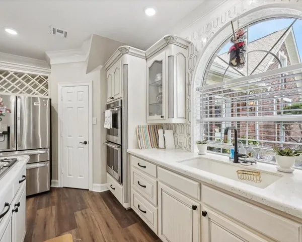 a spacious bathroom with a double vanity sink a mirror and a shower