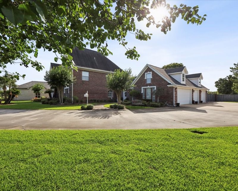 2700 Spurlock Road Nederland, TX 77627 - Photo 3 of 44 a front view of a house with a yard and garage