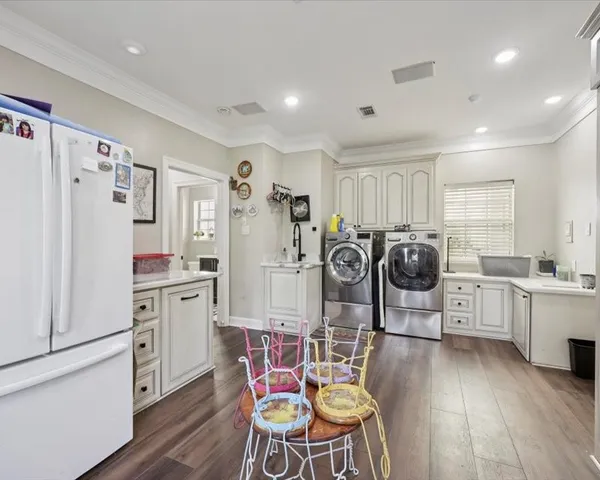 a kitchen with stainless steel appliances a refrigerator stove microwave and white cabinets