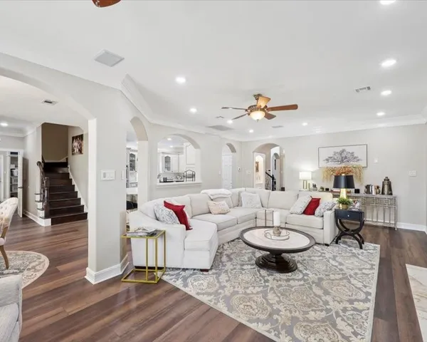 a living room with furniture and wooden floor