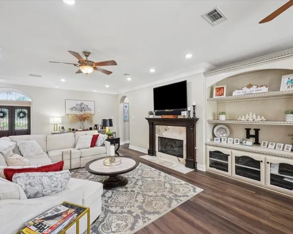 a living room with furniture and a fireplace