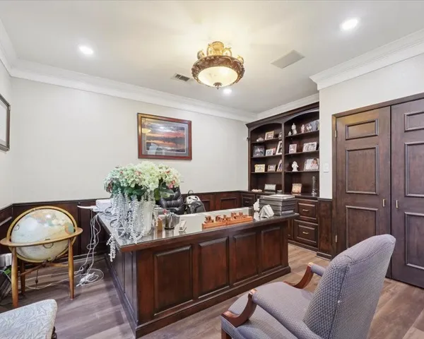 a kitchen with stainless steel appliances granite countertop a stove a chimney a sink and cabinets