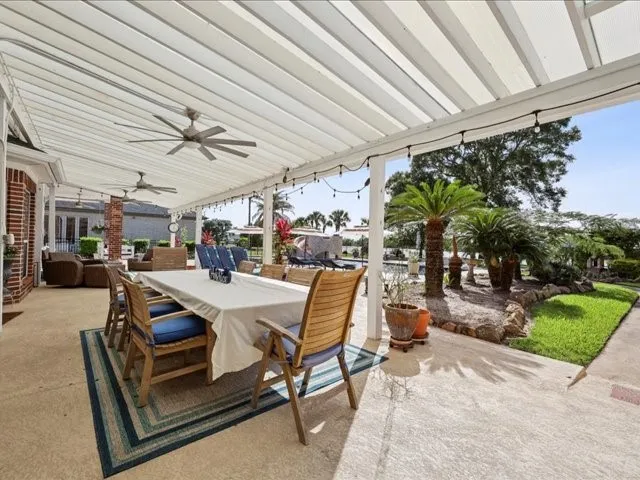 a view of a patio with a table and chairs and a barbeque