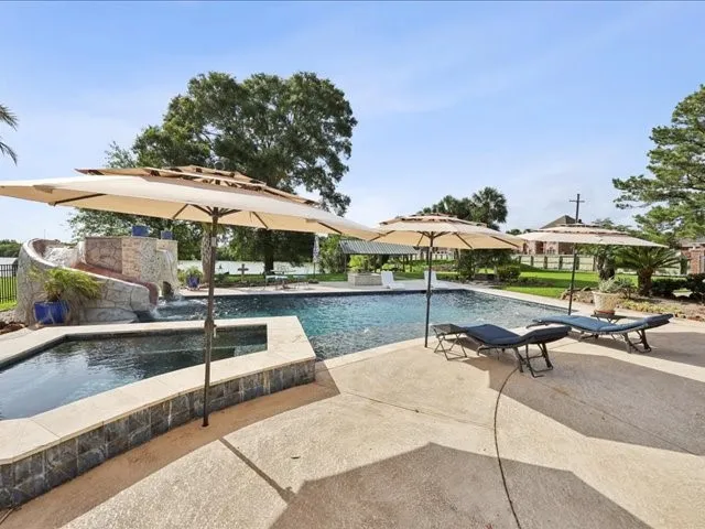a swimming pool with outdoor seating and yard
