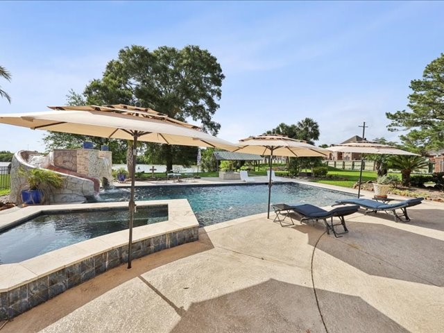 2700 Spurlock Road Nederland, TX 77627 - Photo 40 of 44 a swimming pool with outdoor seating and yard