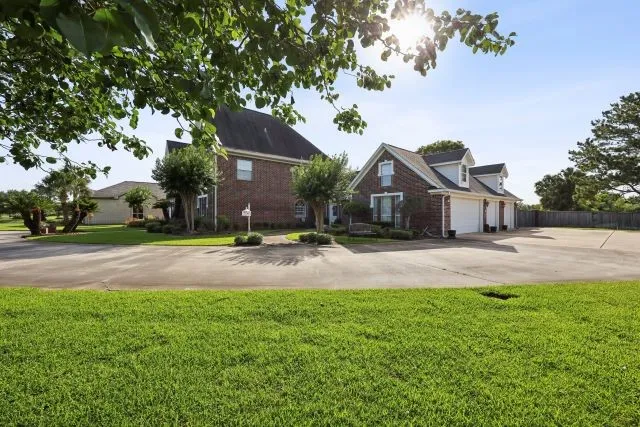 a front view of house with yard and green space