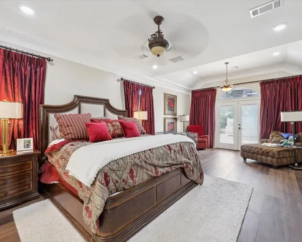 a spacious bedroom with a bed and a couch