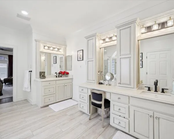 a spacious bathroom with a granite countertop sink and a mirror
