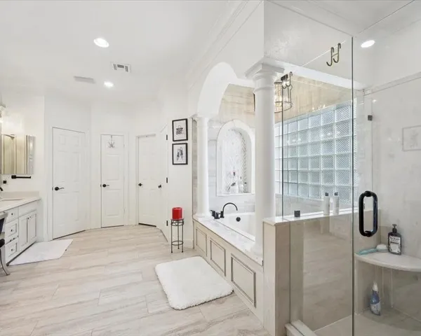 a bathroom with a tub sink and mirror