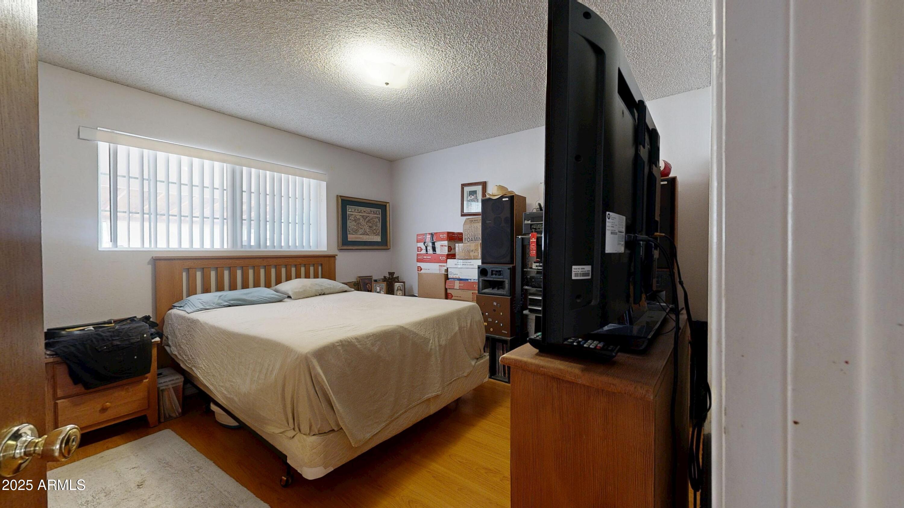 1432 South Lawther Drive Apache Junction, AZ 85120 - Photo 13 of 29 a bedroom with a bed and a window