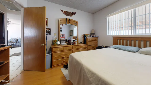 a bedroom with a bed and a dresser