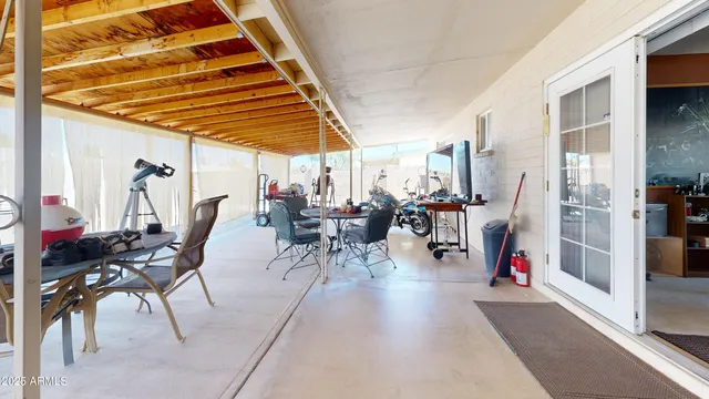 a view of a patio with dining table and chairs