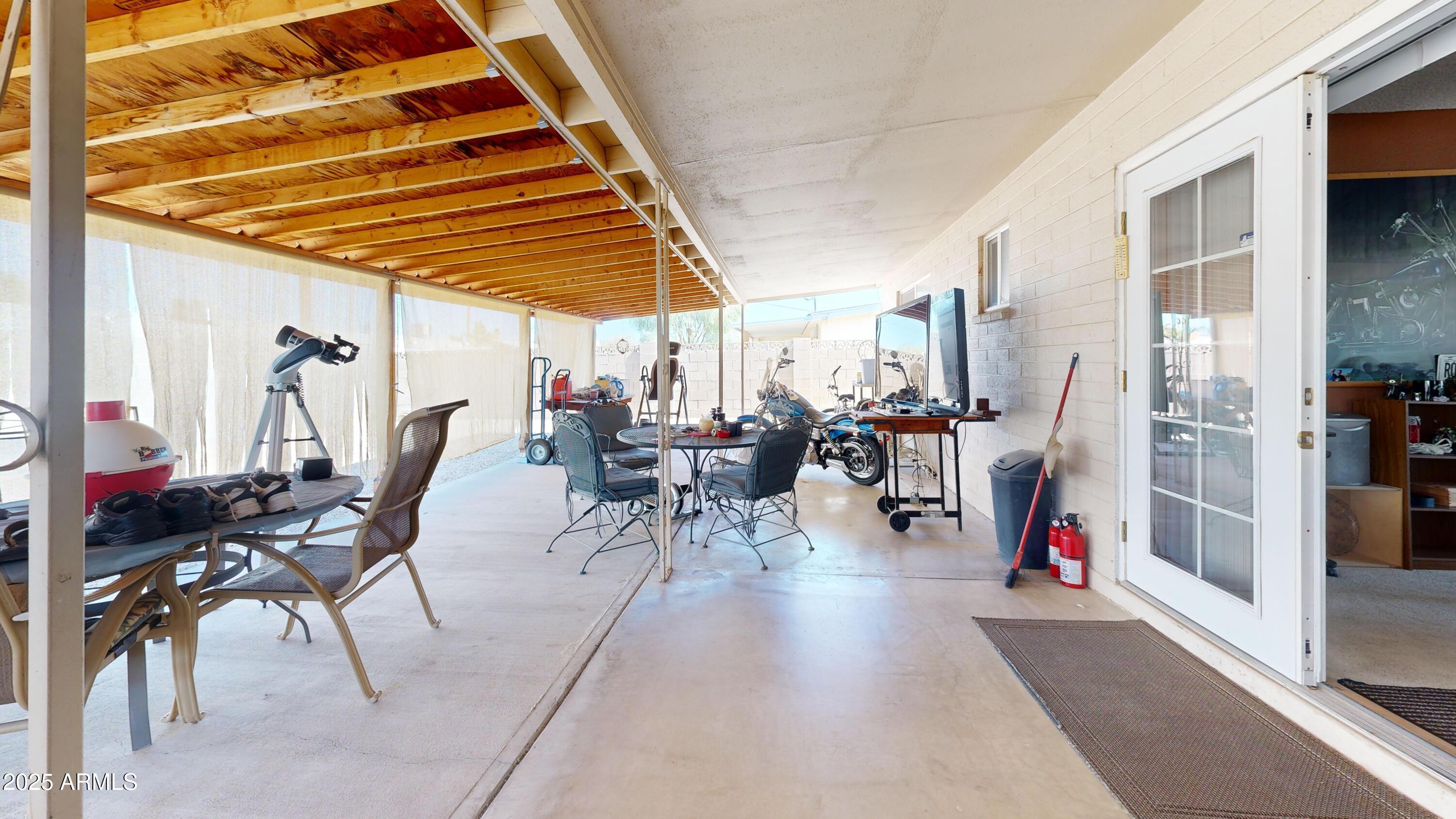 1432 South Lawther Drive Apache Junction, AZ 85120 - Photo 17 of 29 a view of a patio with dining table and chairs
