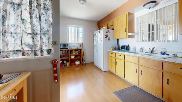 a kitchen with stainless steel appliances sink refrigerator and window