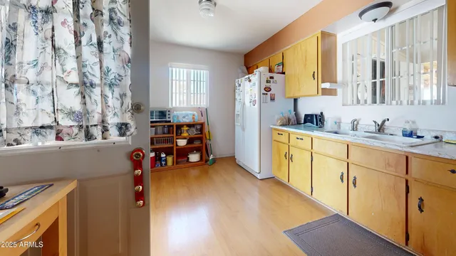a kitchen with stainless steel appliances sink refrigerator and window