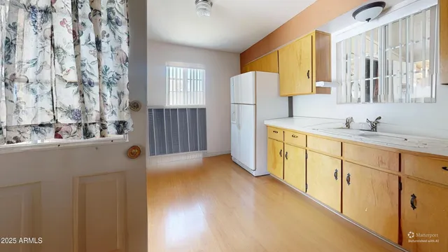 a kitchen with stainless steel appliances a refrigerator and a sink