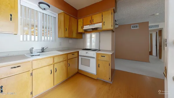 a kitchen with stainless steel appliances granite countertop a sink a stove and a refrigerator