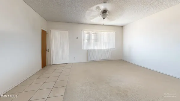 an empty room with a empty space and windows