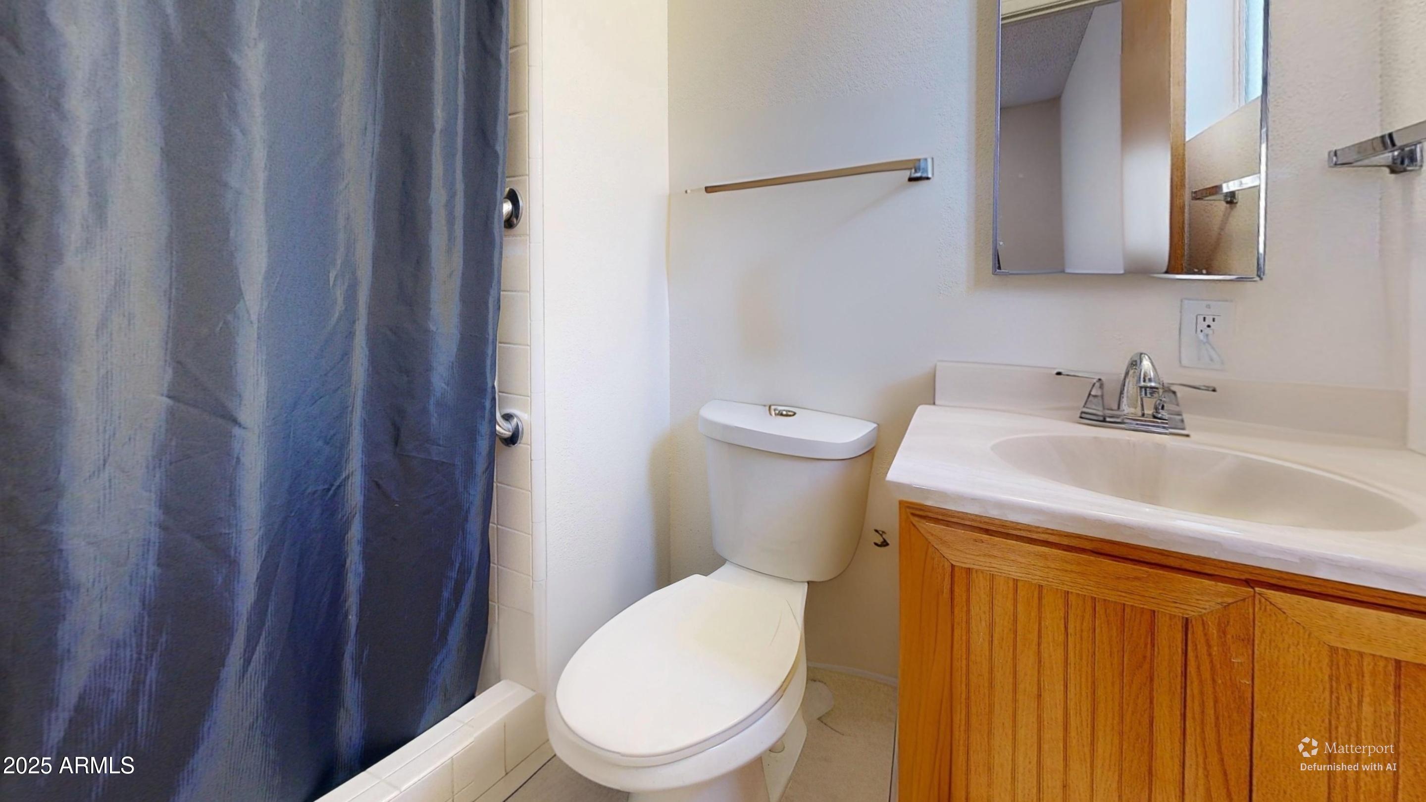 1432 South Lawther Drive Apache Junction, AZ 85120 - Photo 25 of 29 a white toilet sitting next to a bathroom sink