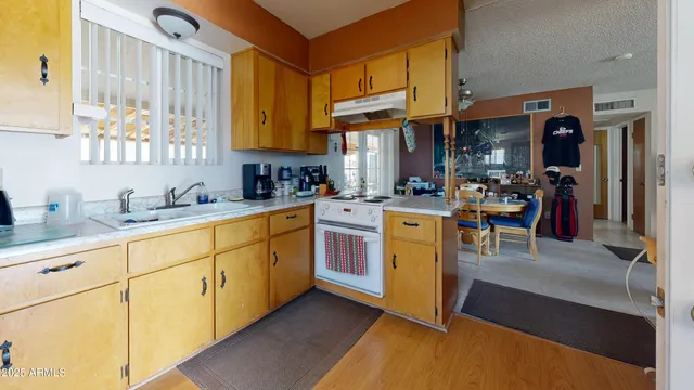 a kitchen with cabinets and wooden floor